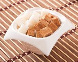 Close-up of cubes of brown and white sugar photo