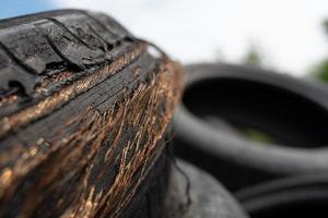 Old black car tires. Unauthorized dump. photo