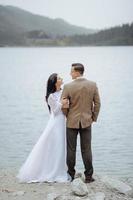 Loving couple on the background of the Sea-eye lake in Poland photo