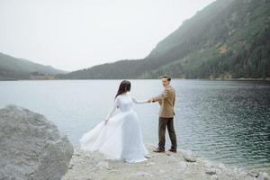 Loving couple on the background of the Sea-eye lake in Poland photo