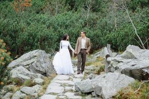 Beautiful couple walking among rocks photo