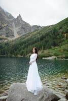 Bride near the Sea-eye lake in Poland photo
