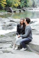 incredibly beautiful and lovely couple on the background of a mountain river photo