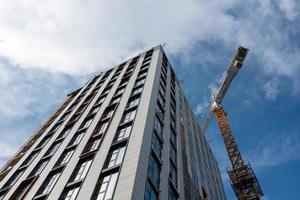 Crane and building construction site against blue sky photo