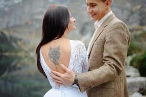 Loving couple on the background of the Sea-eye lake in Poland photo