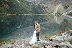 Loving couple on the background of the Sea-eye lake in Poland photo