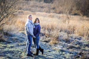 outdoor fashion portrait of young sensual couple in cold winter wather. love and kiss photo