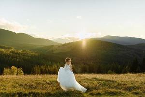 Bride in the mountains. The concept of lifestyle and wedding. photo