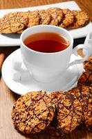Black tee and tasty cookies at breakfast photo