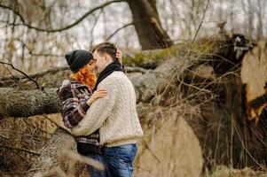 Hug in the autumn park under a tree photo