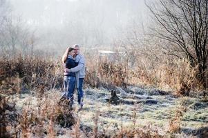 outdoor fashion portrait of young sensual couple in cold winter wather. love and kiss photo