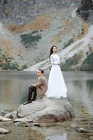 Loving couple on the background of the Sea-eye lake in Poland photo