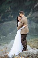 Loving couple on the background of the Sea-eye lake in Poland photo