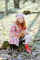 Little girl with a rabbit photo