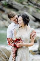 bride and groom. Wedding ceremony near a mountain river photo