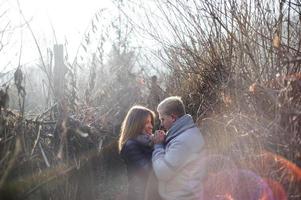 Couple embracing each other outdoors in snow photo