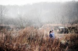 outdoor fashion portrait of young sensual couple in cold winter wather. love and kiss photo