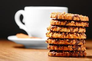 Black tee and tasty cookies at breakfast photo