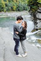 incredibly beautiful and lovely couple on the background of a mountain river photo