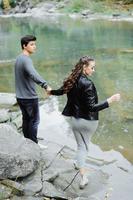 incredibly beautiful and lovely couple on the background of a mountain river photo
