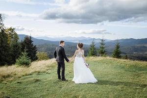 Beautiful bride and groom at the mountains photo