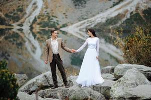 Loving couple on the background of the Sea-eye lake in Poland photo