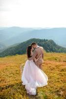 Young love couple celebrating a wedding in the mountains photo