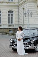 wedding couple with wedding car photo