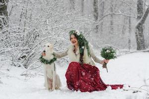 Portrait of a beautiful young bride with a bouquet. Winter wedding ceremony. photo