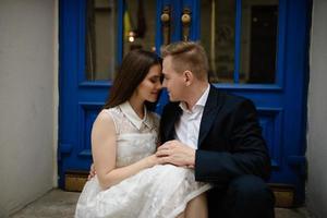 Happy smiling attractive young couple on date sitting in street cafe in summer, sharing drink, looking at each other with love, flirting, having fun together photo