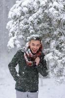 Portrait of a bearded groom in a stylish suit with suspenders and bow-tie in winter at a ski resort photo