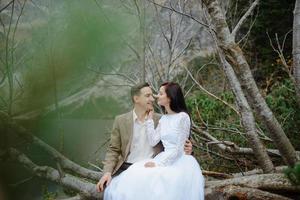 Loving couple on the background of the Sea-eye lake in Poland photo