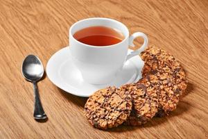 Black tee and tasty cookies at breakfast photo