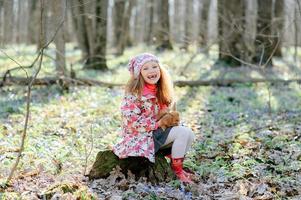 Little girl with a rabbit photo