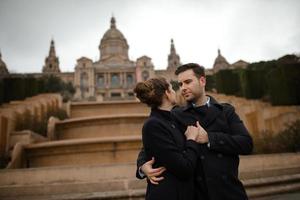 Young beautiful loving Hispanic couple walks under an umbrella during the rain. photo