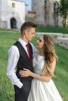 Bride and groom in a wheat field. The couple hugs during sunset photo