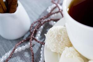 heart-shaped chocolates with candies in coconut flakes of beads photo