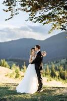 Beautiful bride and groom at the mountains photo