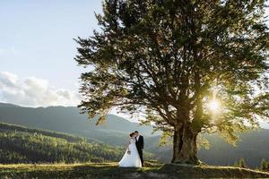 Beautiful bride and groom at the mountains photo