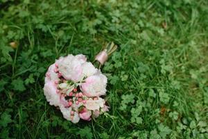 Bridal bouquet on the green grass. photo