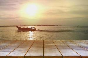 Empty wooden table space platform and Boats on the sea and sky background for product display montage , Wood table for product placement photo