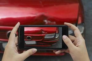 Hand holding smart phone take a photo at The scene of a car crash, car accident for insurance