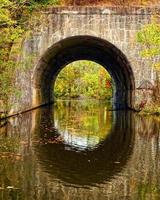 Arch over river in fall photo