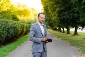 Young successful businessman shows money in his hand. photo