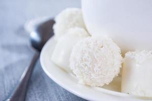 heart-shaped chocolates with candies in coconut flakes of beads photo