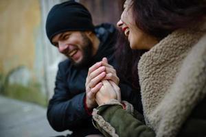 Young hipster couple in love hugging near the bonfire. Winter weather. Romantic love story photo