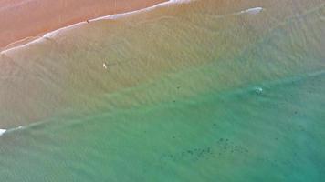 Amazing scenic drone aerial view of the beach and ocean with calm waves during a sunset with vibrant colors. Algarve, Portugal. Clear waters. Holidays and Vacations. Background. Beach with rocks. video