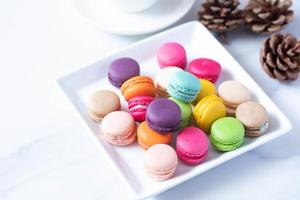 colorful macarons in white plate photo