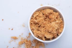 dried shredded pork in a white ceramic cup photo