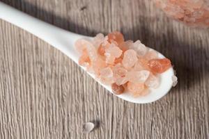 Himalayan pink salt in a white spoon